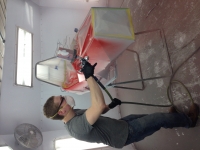 Sean Salzer spraying paint at Jacobsen Autobody